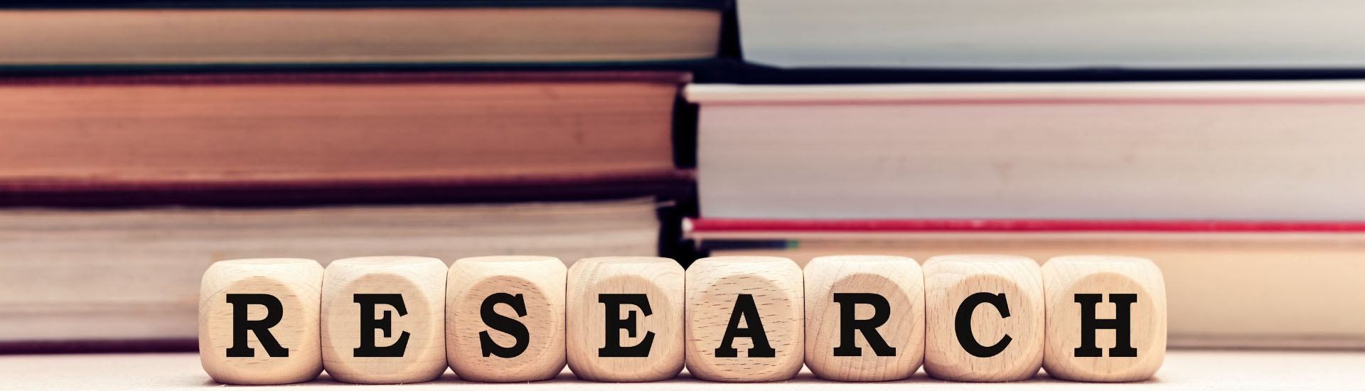 Research spelled in wooden letters beside books